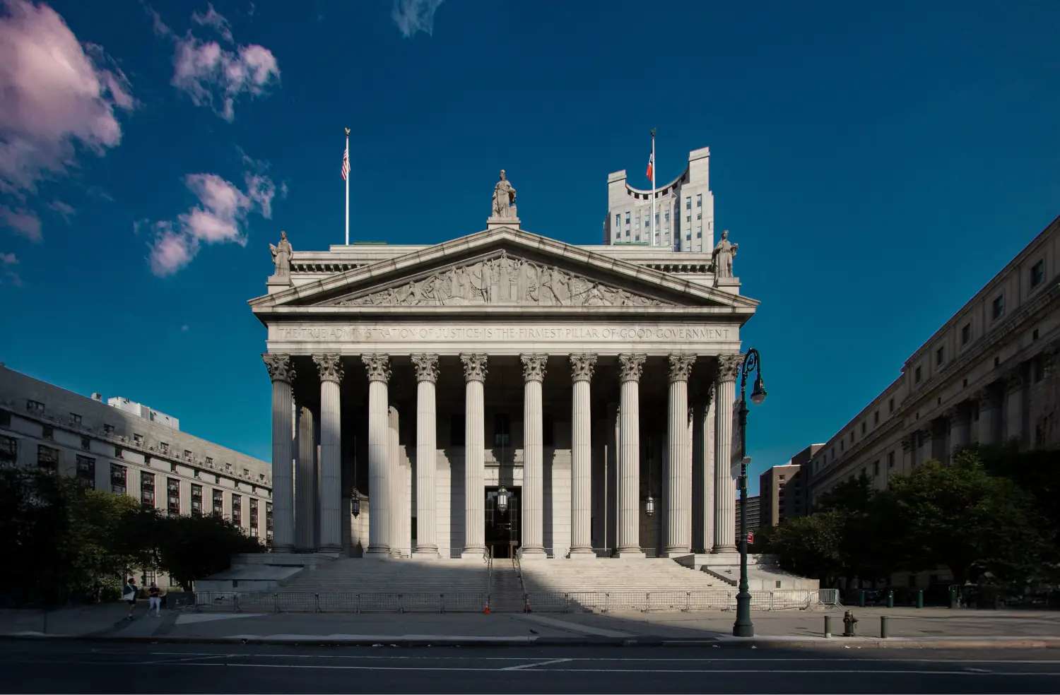 Classical courthouse exterior with columns and stone sculptures