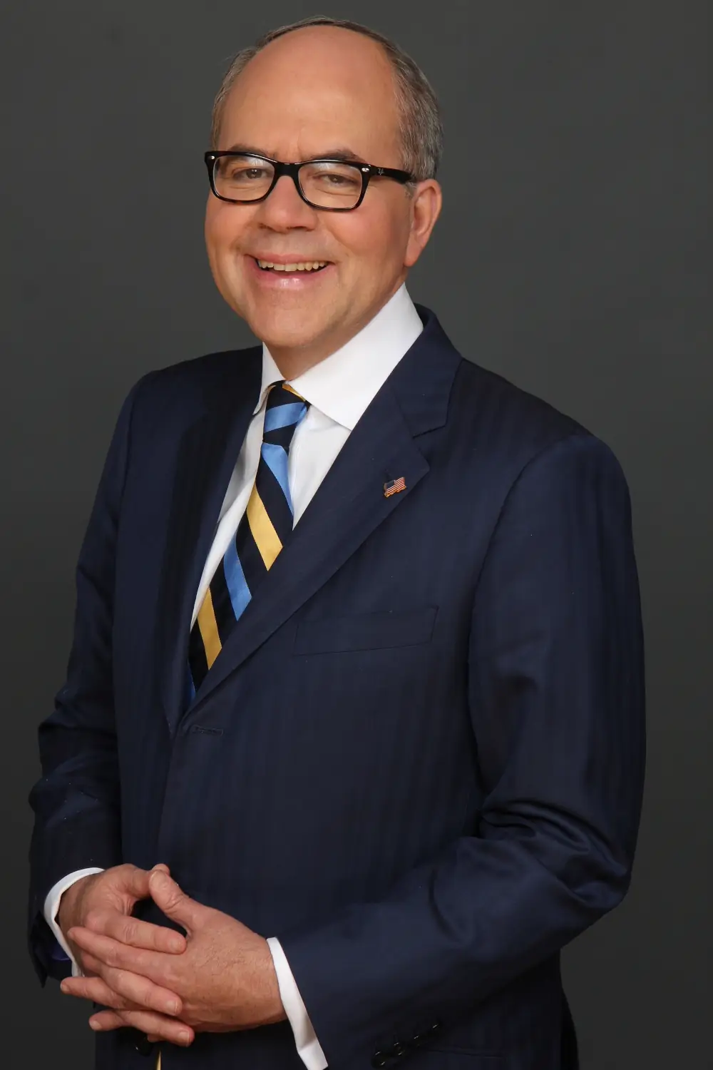 Professional portrait of attorney Peter James Johnson in a navy suit and striped tie
